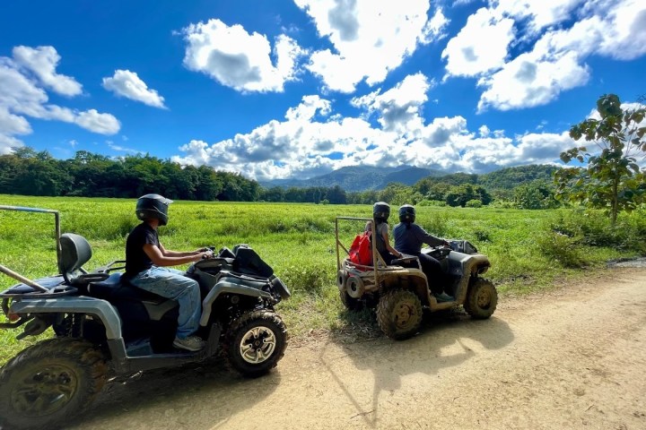 a truck parked on the side of a dirt road