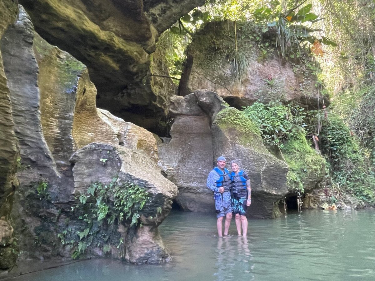 a person standing on a rock in the water