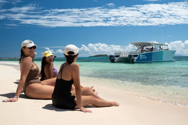a woman sitting at a beach