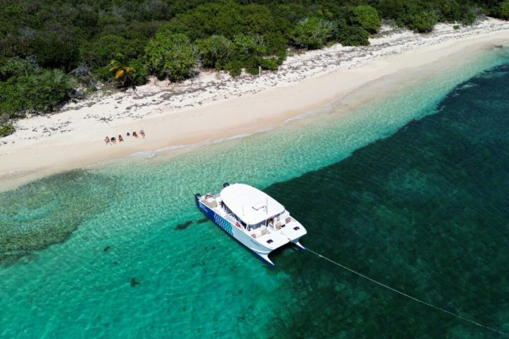 a beach with a surf board on a body of water