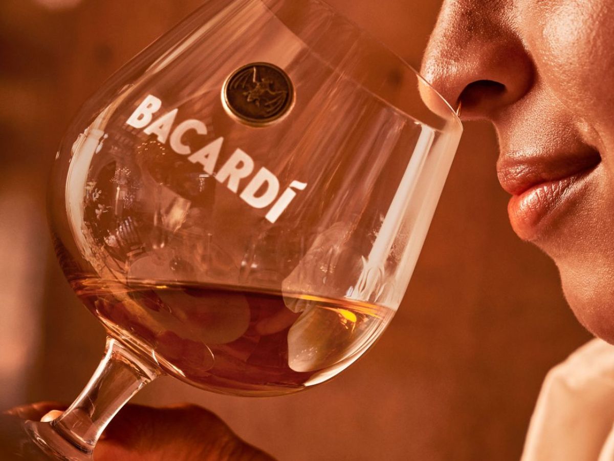 a close up of a person holding a wine glass