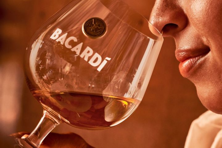 a close up of a person holding a wine glass