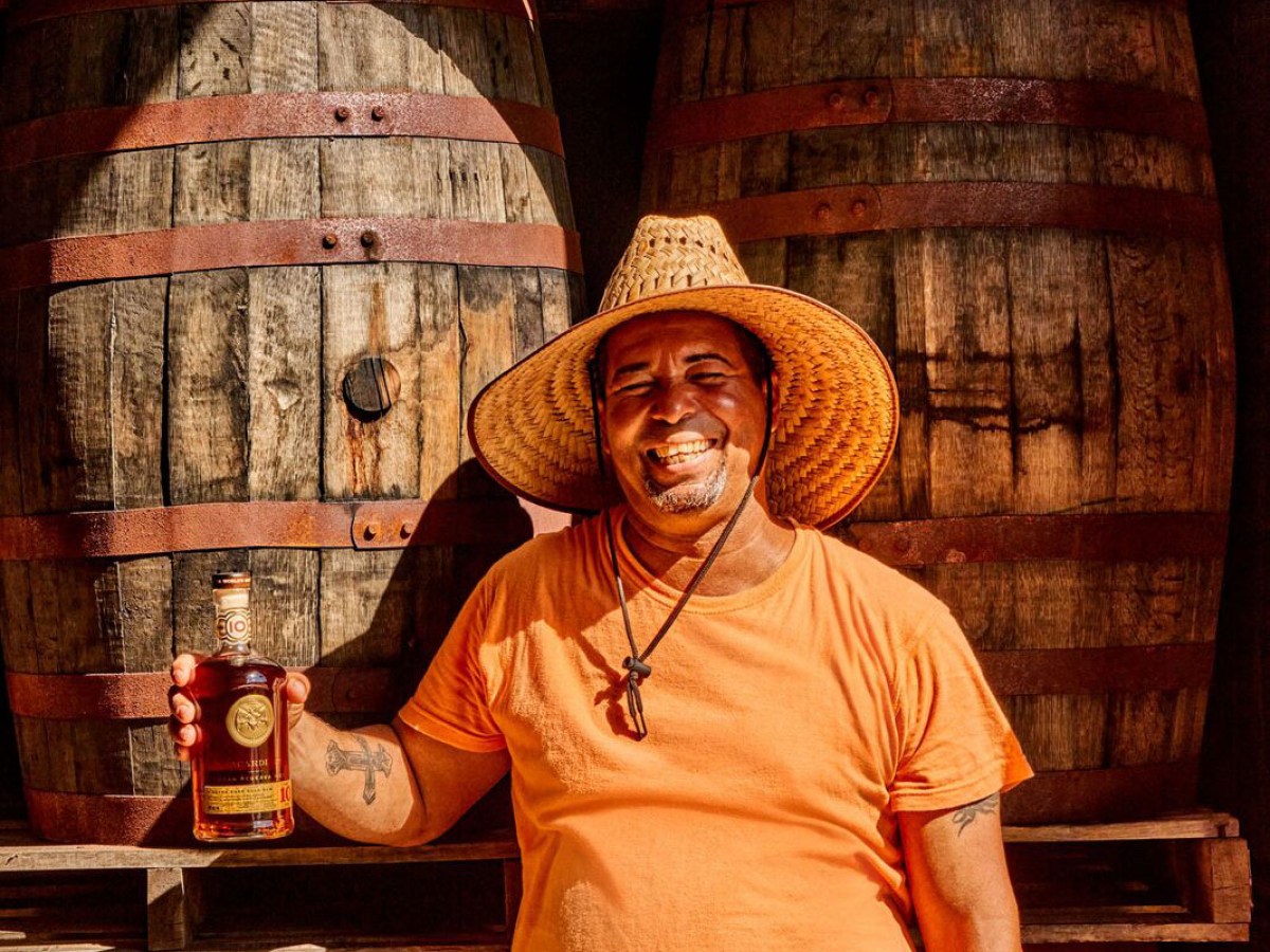a person sitting in front of a barrel