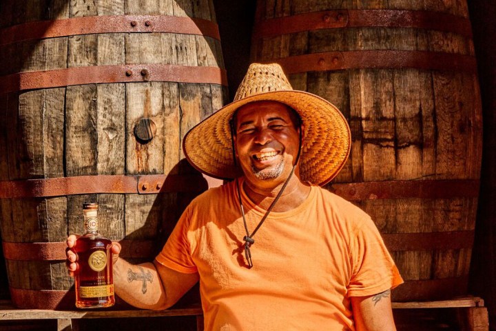 a person sitting in front of a barrel